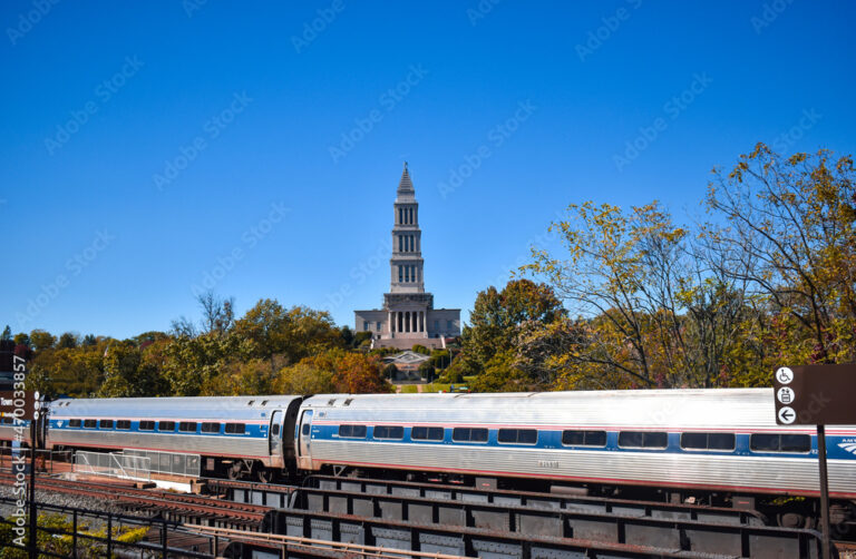 Alexandria, Virginia, USA - November 1, 2021: King Street  - Old Town WMATA Metro Station, looking at the George Washington Masonic Temple, with an Amtrak Train in the Foreground on a Fall Afternoon